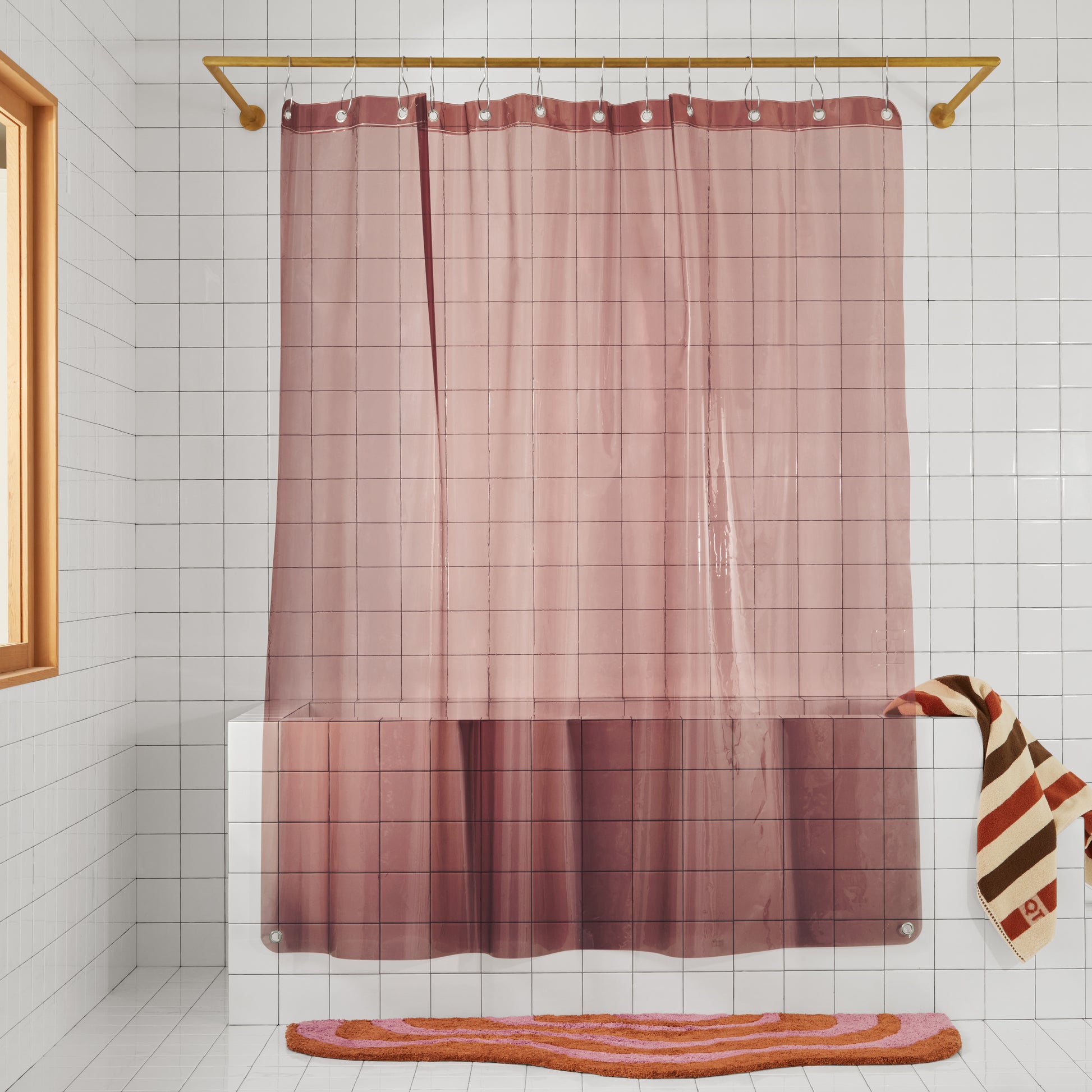 Sun Shower in rose front view of curtain hanging in a white tiled bathroom.
