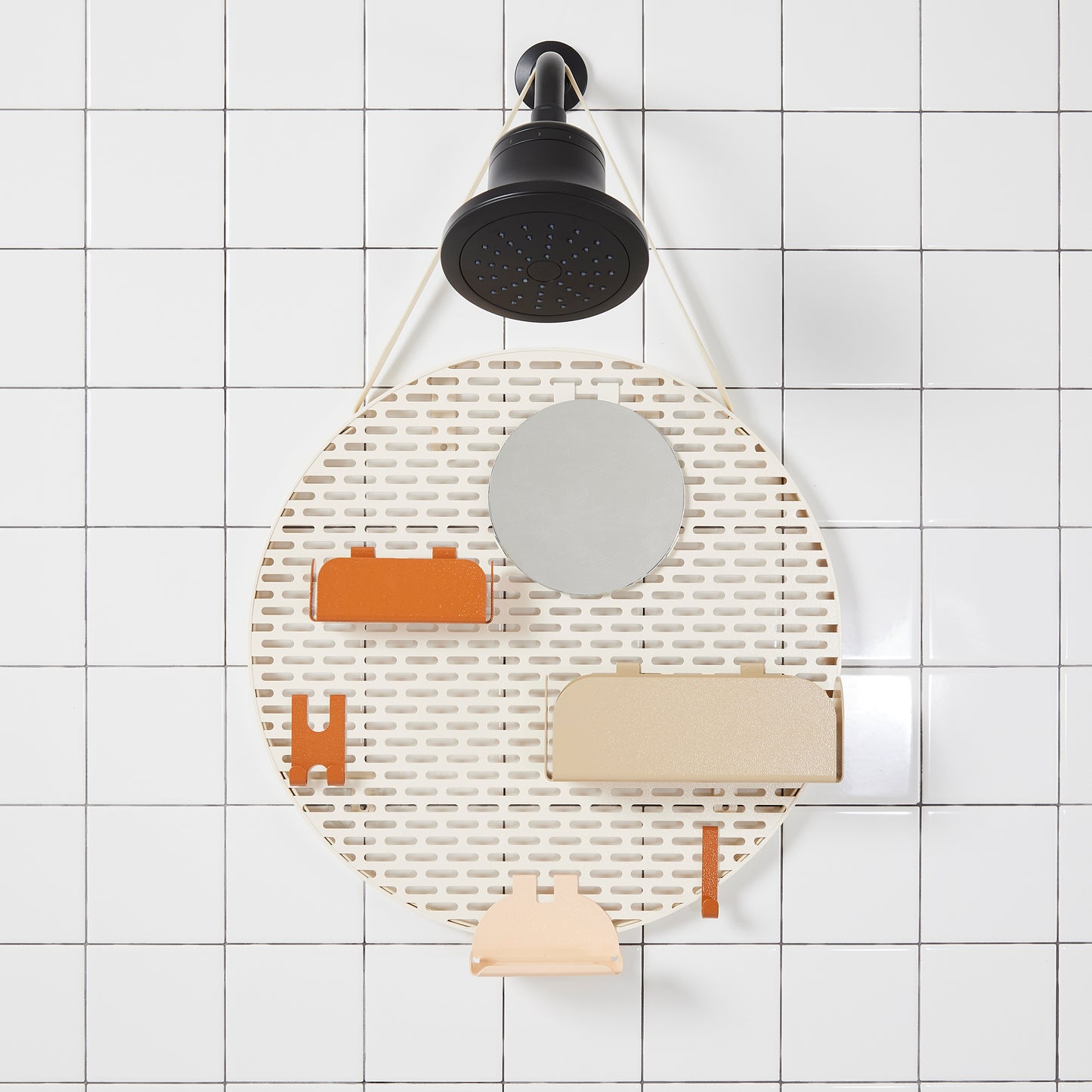 The spot modular shower organizer with shelving pieces arranged hanging in a white tiled shower.