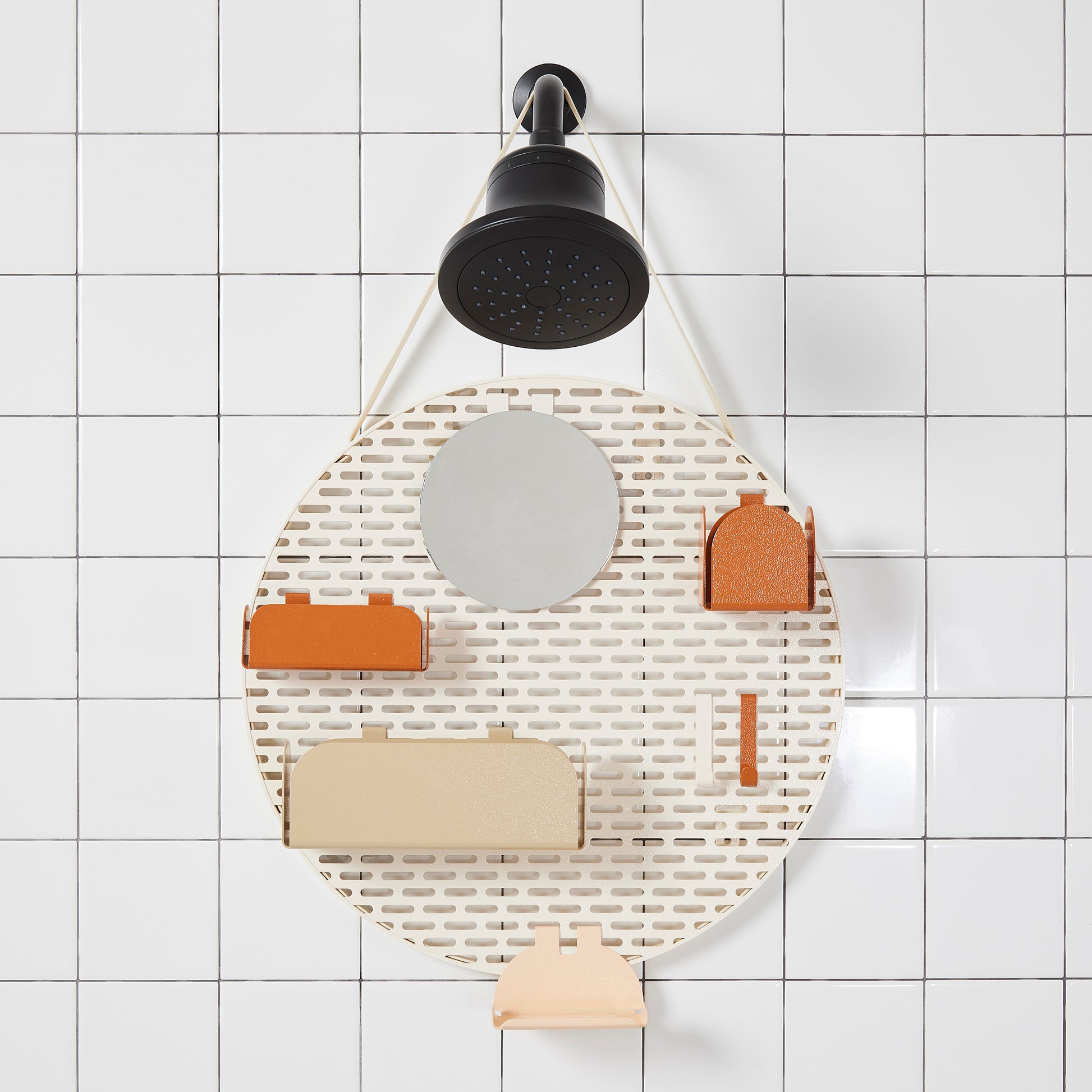The spot modular shower organizer with shelving pieces arranged hanging in a white tiled shower.