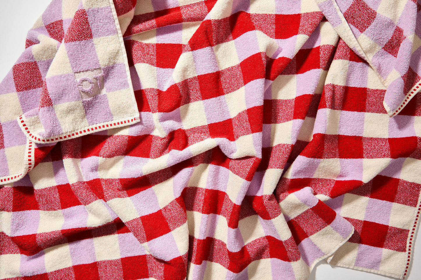 Detail view of tam bath sheet with red, lavender, and cream checks. 
