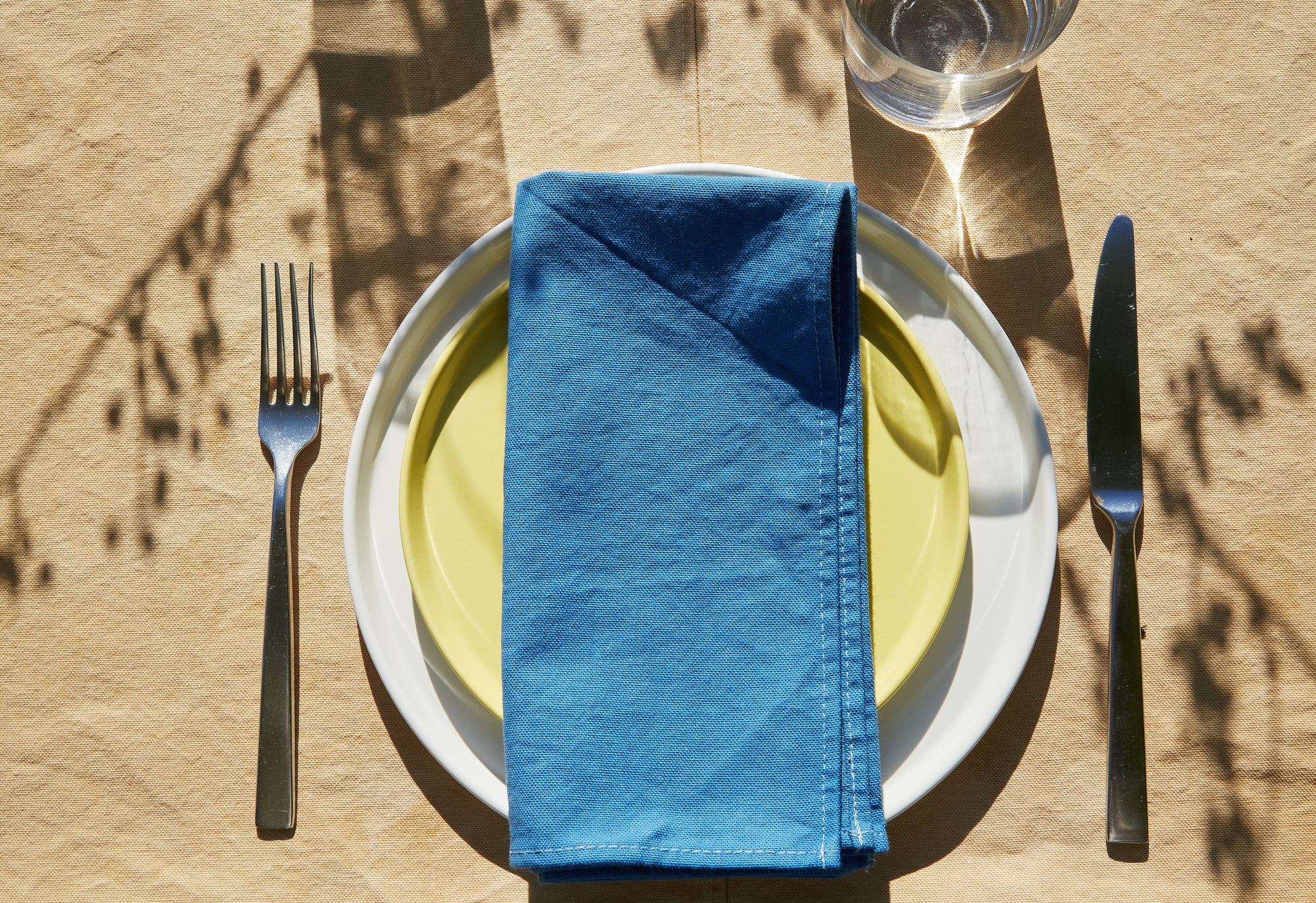 Naturally Dyed Tablecloth for 4 in Eucalyptus detail view with tableware